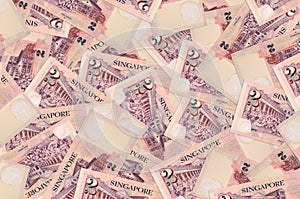 2 Singaporean dollars bills lies in big pile. Rich life conceptual background