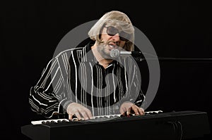 Singer accompanying himself on electric piano