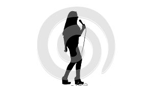 Singer dances to the beat of her song. White background. Silhouette. Side view