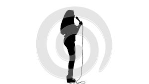 Singer dances to the beat of her song. White background. Silhouette. Side view. Slow motion