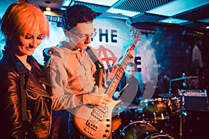 Singer and guitar player on stage during band gig photo