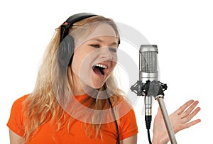 Singer in headphones singing with the microphone