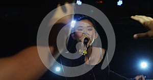 Singer performing on stage at a concert 4k