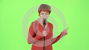 Singer performs her song of authorship. Green screen