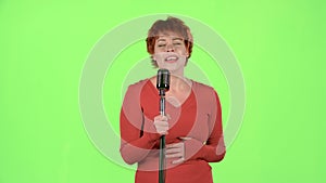 Singer performs her song of authorship. Green screen