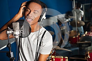 Singer recording a track in studio photo
