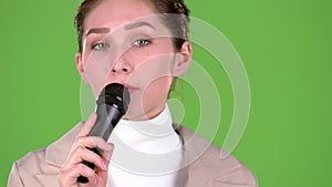 Singer sings a cheerful and melodic song. Green screen