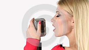 Singer sings in a retro microphone. White background. Side view. Close up
