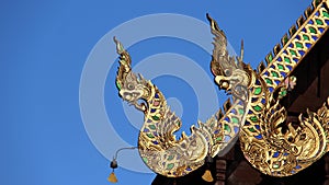 Singha spew out Nagas temple roof decorated with stained glass