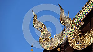 Singha spew out Nagas temple roof decorated with stained glass photo