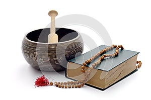 Singing bowl, book and wooden rosary.