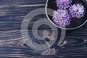 Singing bowl with candles with pebbles on dark wooden background