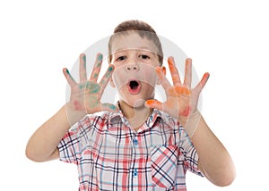 Singing boy with colorful painted fingers spread