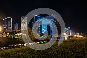 Singing light and music fountain on background of panorama of beautiful buildings at night