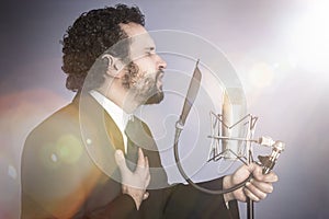 Singing man with black suit and microphone