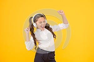 Singing in tune. Cute small child taking her singing lessons on yellow background. Adorable little girl singing her