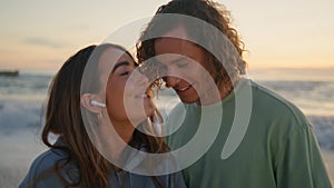 Singing woman enjoying music with boyfriend at sunrise beach. Lovers having fun