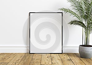 Single 8x10 Vertical Black Frame mockup with green plant in concrete vase on wooden floor and white wall