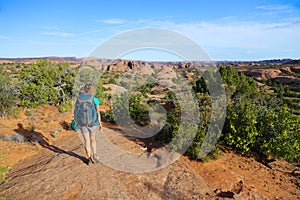 Single active female backpacking in desert southwest landscape