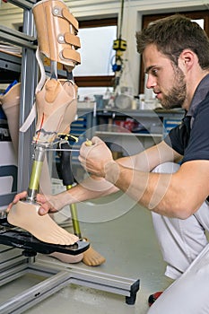 Single adult working on prosthetic leg adjustment