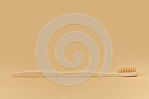 Single Bamboo wooden toothbrushe on beige background.