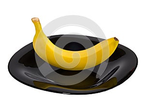 Single banana, in a dish isolated on a white background