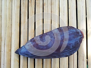 Single Banana Flower or Blossom on Bamboo Surface