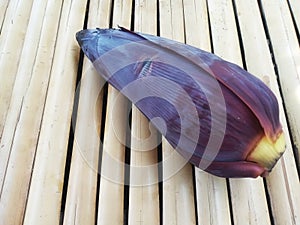 Single Banana Flower or Blossom on Bamboo Surface