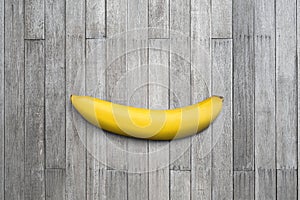 Single banana on old wooden top table