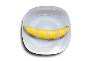 Single banana on white ceramic plates isolated on white background with clipping paths