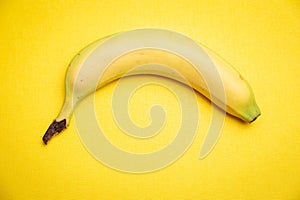 Single banana yellow background.