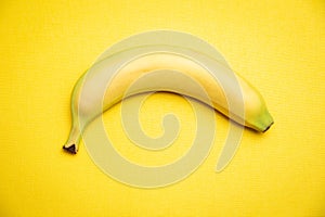 Single banana yellow background.