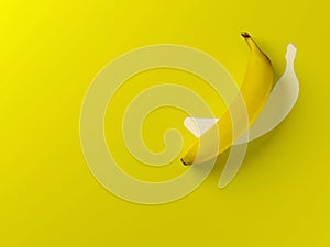 Single banana on yellow background with copy space