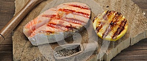 Single BBQ Grilled Salmon Steak On The Wood Board