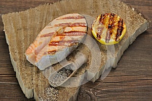 Single BBQ Grilled Salmon Steak On The Wood Board