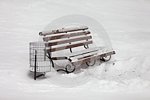 Single bench covered with snow in winter park