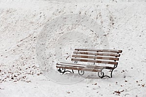 Single bench covered with snow in winter park