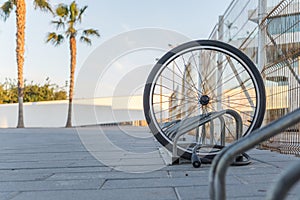 a single bicycle wheel on the street due to stealing