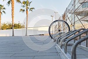 a single bicycle wheel on the street due to stealing