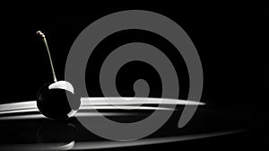 Single Black Cherry in Water Droplet on Dark Surface