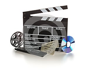 Single, black, open movie clapper or clapper-board with dvd movie disc, film reel, remote control and movie theatre tickets on