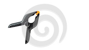 Single black plastic spring clamp isolated over white background