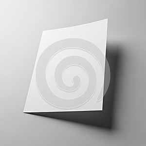 A single blank sheet of paper is positioned at an angle against a flat surface, casting