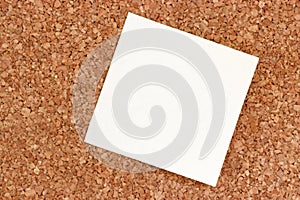 Sticky note on a cork pinboard