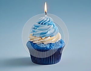 Single blue Cupcake With a Burning Candle on blue Background