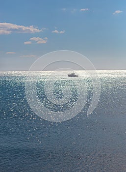 single boat in the distance under moonlight