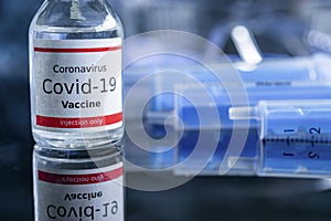 A single bottle vial of Covid-19 vaccine. Medical concept vaccination hypodermic injection treatment. Vaccine and syringe injectio