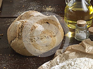 Single bread on a rustic wooden countertop photo