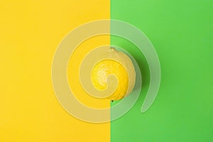 Single Bright Ripe Lemon on Contrast Background from Combination of Yellow Green Colors. Styled Creative Image.