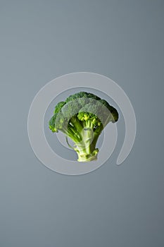 Single broccoli head is floating in the air